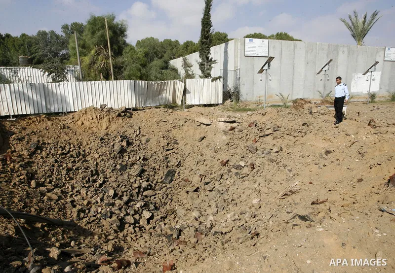 A member of the Palestinian security forces inspects the damage from an Israeli air strike at the Rafah border crossing with Egypt in the southern Gaza Strip on August 25, 2014. Violence reverberated across Gaza with fou...