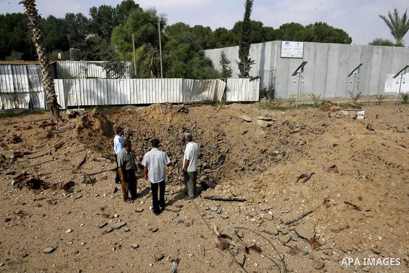 A member of the Palestinian security forces inspects the damage from an Israeli air strike at the Rafah border crossing with Egypt in the southern Gaza Strip on August 25, 2014. Violence reverberated across Gaza with fou...