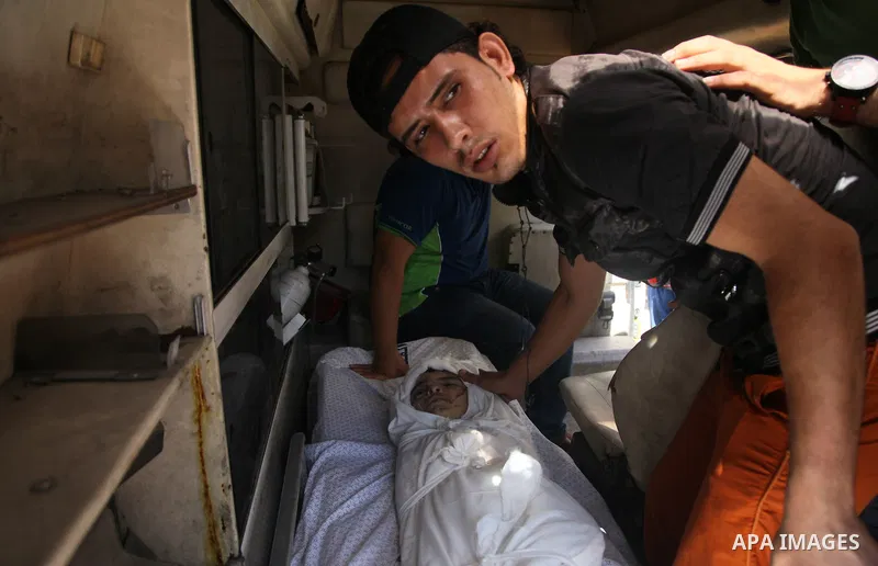 Palestinian mourners carry the body of boy,during his funeral in Gaza City, whom medics said was killed in an Israeli air strike on August 25, 2014. Photo by Ezz al-Zanoun