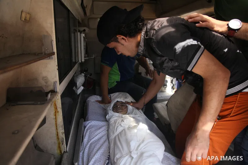 Palestinian mourners carry the body of boy,during his funeral in Gaza City, whom medics said was killed in an Israeli air strike on August 25, 2014. Photo by Ezz al-Zanoun