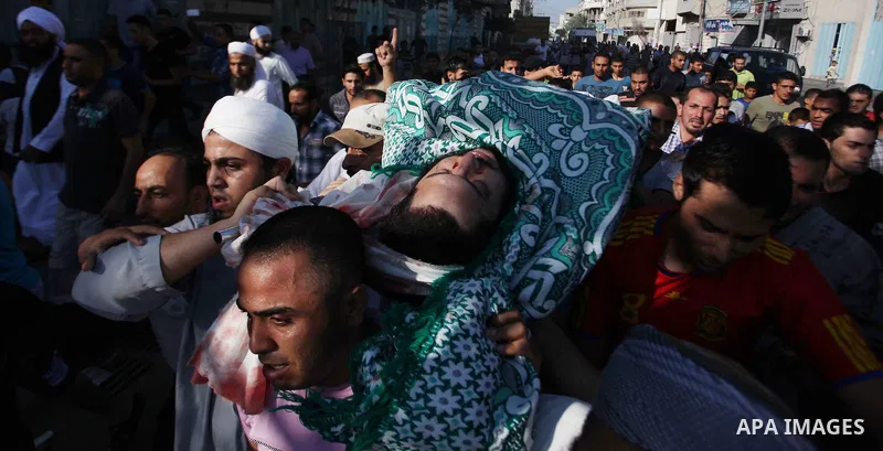 Palestinian mourners carry the body of Basim Hijazi 36, after his car was targeted in an Israeli air strike also killing his brother Ahmed, 26, and a friend during their funeral in Gaza City on August 25, 2014. Palestini...