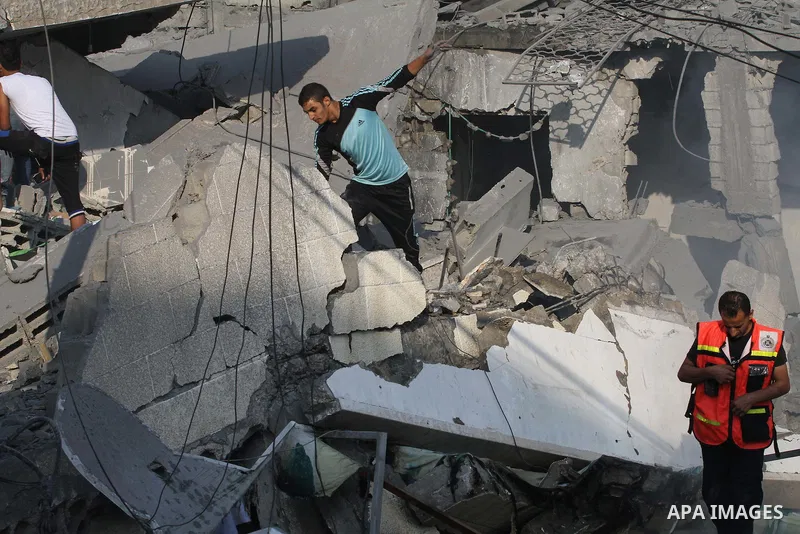 Palestinian residents inspect the remains of a building that was destroyed by an Israeli air strike in Gaza City on August 26, 2014. Israeli air strikes launched before dawn on Tuesday killed two Palestinians and destroy...