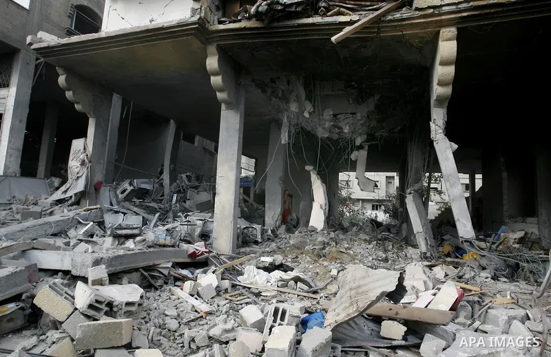 Palestinian residents salvage items from the remains of their homes that were destroyed by an Israeli air strike on Rafah town in the southern Gaza Strip on August 26, 2014. Israeli fire killed 10 Palestinians across Gaz...
