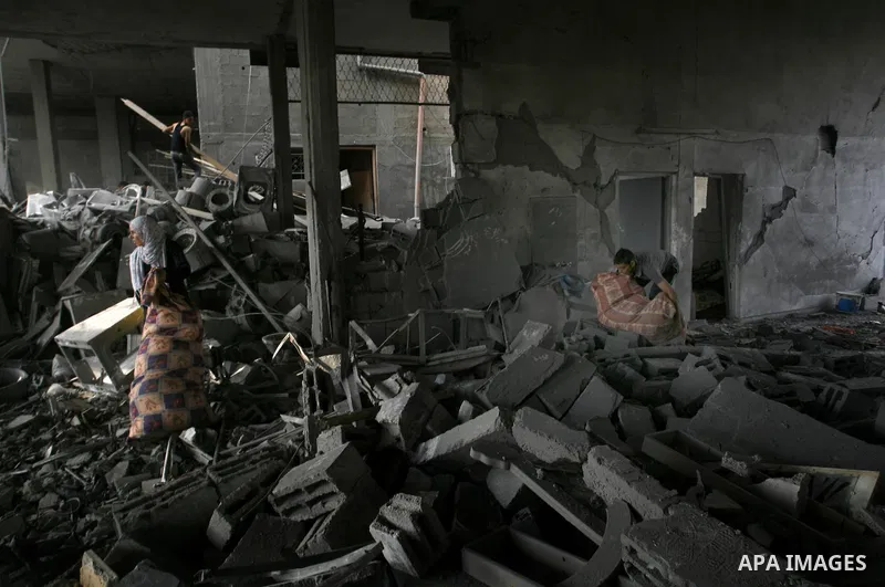 Palestinian residents salvage items from the remains of their homes that were destroyed by an Israeli air strike on Rafah town in the southern Gaza Strip on August 26, 2014. Israeli fire killed 10 Palestinians across Gaz...