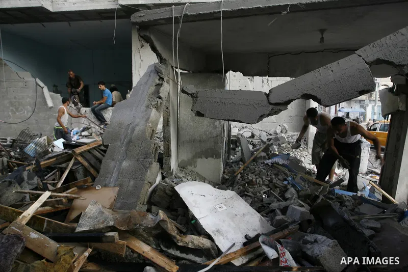 Palestinian residents salvage items from the remains of their homes that were destroyed by an Israeli air strike on Rafah town in the southern Gaza Strip on August 26, 2014. Israeli fire killed 10 Palestinians across Gaz...