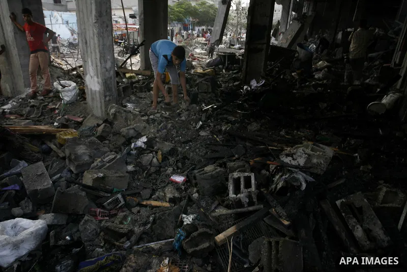 Palestinian residents salvage items from the remains of their homes that were destroyed by an Israeli air strike on Rafah town in the southern Gaza Strip on August 26, 2014. Israeli fire killed 10 Palestinians across Gaz...