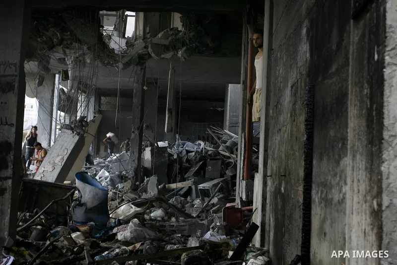 Palestinian residents salvage items from the remains of their homes that were destroyed by an Israeli air strike on Rafah town in the southern Gaza Strip on August 26, 2014. Israeli fire killed 10 Palestinians across Gaz...