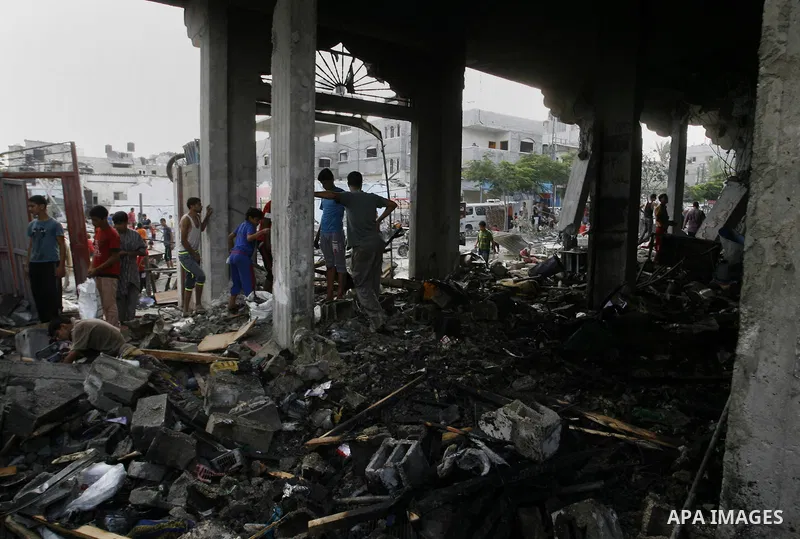 Palestinian residents salvage items from the remains of their homes that were destroyed by an Israeli air strike on Rafah town in the southern Gaza Strip on August 26, 2014. Israeli fire killed 10 Palestinians across Gaz...