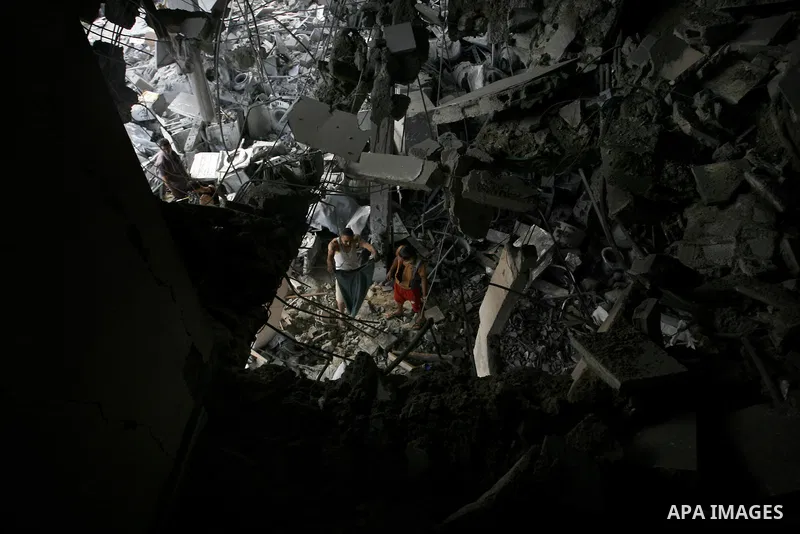 Palestinian residents salvage items from the remains of their homes that were destroyed by an Israeli air strike on Rafah town in the southern Gaza Strip on August 26, 2014. Israeli fire killed 10 Palestinians across Gaz...
