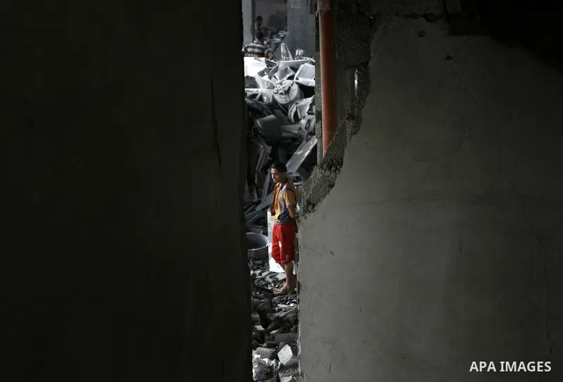A Palestinian boy inspects the remains of his homes that was destroyed by an Israeli air strike on August 26, 2014. Israeli fire killed 10 Palestinians across Gaza on August 25, while Egypt proposed a new ceasefire that...
