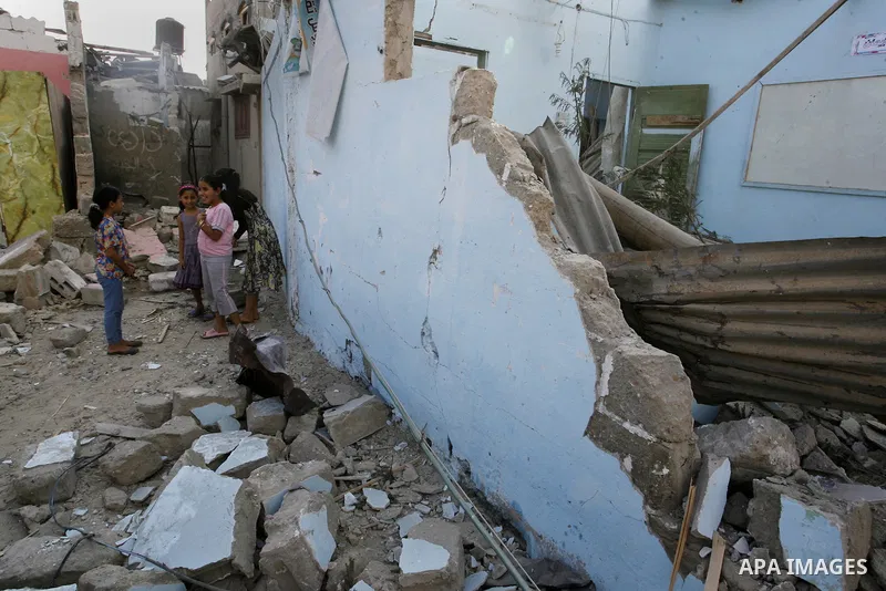 Palestinian children play near the remains of homes that were destroyed by an Israeli air strike on Rafah town in the southern Gaza Strip on August 26, 2014. Israeli fire killed 10 Palestinians across Gaza on August 25,...