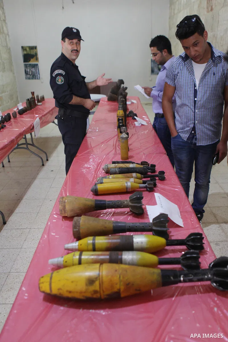 Palestinians attend the opening of gallery contains Israeli damaged equipment, in the West Bank city of Ramallah, on Aug. 26, 2014. Israeli air strikes launched before dawn on Tuesday killed two Palestinians and destroye...