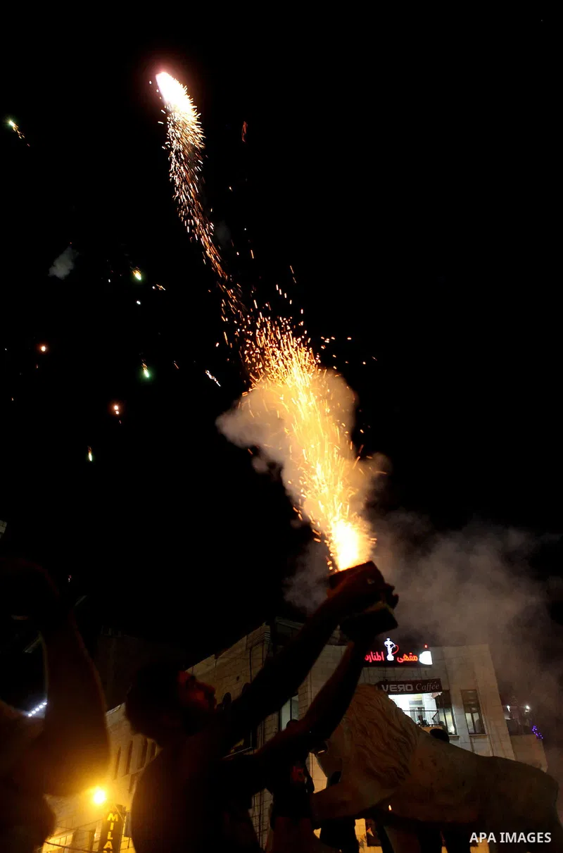 Palestinians celebrate what they said was a victory by Palestinians in Gaza over Israel following a ceasefire, in the West Bank city of Ramallah August 26, 2014. A ceasefire agreement between Israel and the Palestinians...