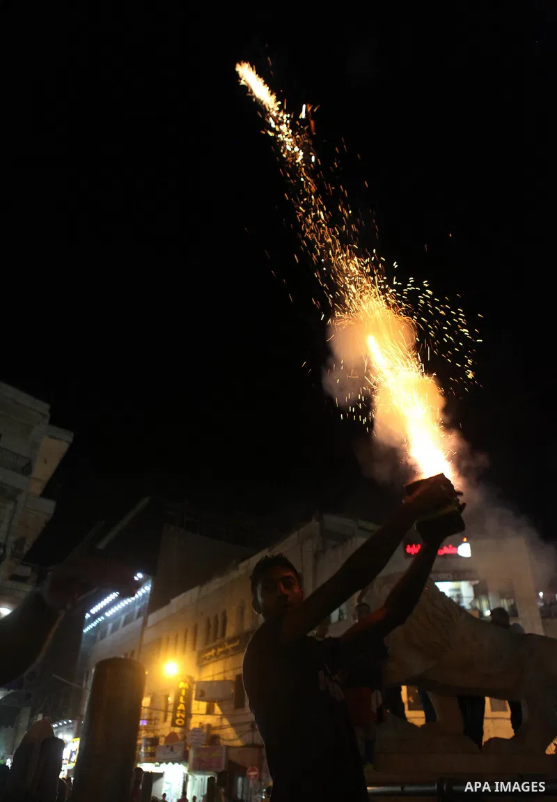 Palestinians celebrate what they said was a victory by Palestinians in Gaza over Israel following a ceasefire, in the West Bank city of Ramallah August 26, 2014. A ceasefire agreement between Israel and the Palestinians...