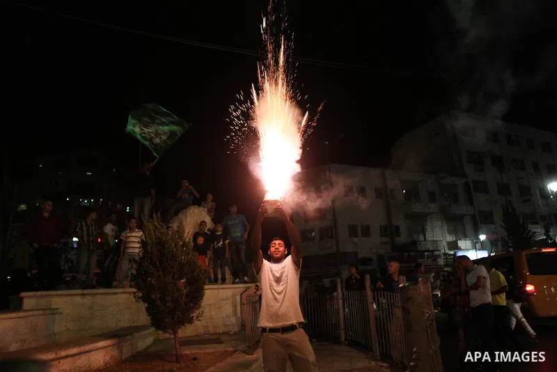 Palestinians celebrate what they said was a victory by Palestinians in Gaza over Israel following a ceasefire, in the West Bank city of Ramallah August 26, 2014. A ceasefire agreement between Israel and the Palestinians...