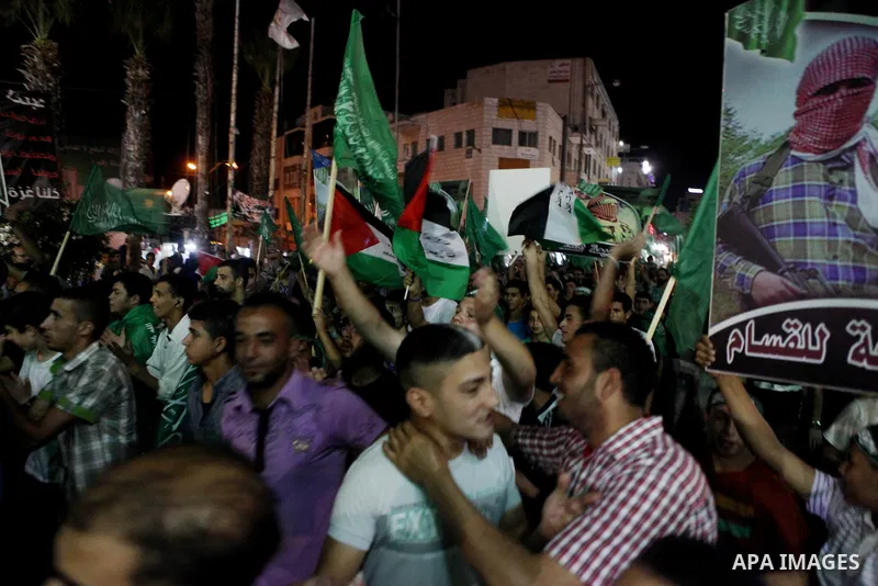 Palestinians celebrate what they said was a victory by Palestinians in Gaza over Israel following a ceasefire, in the West Bank city of Ramallah August 26, 2014. A ceasefire agreement between Israel and the Palestinians...