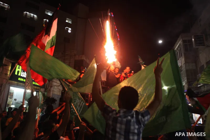 Palestinians celebrate what they said was a victory by Palestinians in Gaza over Israel following a ceasefire, in the West Bank city of Ramallah August 26, 2014. A ceasefire agreement between Israel and the Palestinians...
