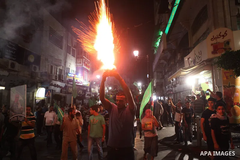 Palestinians celebrate what they said was a victory by Palestinians in Gaza over Israel following a ceasefire, in the West Bank city of Ramallah August 26, 2014. A ceasefire agreement between Israel and the Palestinians...