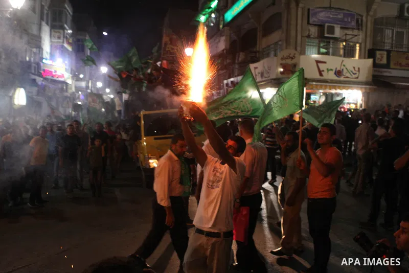 Palestinians celebrate what they said was a victory by Palestinians in Gaza over Israel following a ceasefire, in the West Bank city of Ramallah August 26, 2014. A ceasefire agreement between Israel and the Palestinians...