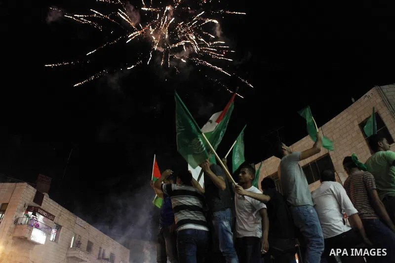 Palestinians celebrate what they said was a victory by Palestinians in Gaza over Israel following a ceasefire, in the West Bank city of Ramallah August 26, 2014. A ceasefire agreement between Israel and the Palestinians...