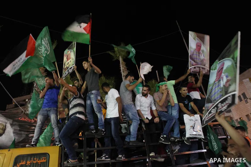 Palestinians celebrate what they said was a victory by Palestinians in Gaza over Israel following a ceasefire, in the West Bank city of Ramallah August 26, 2014. A ceasefire agreement between Israel and the Palestinians...