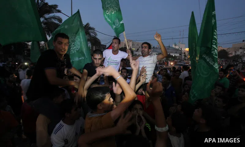Palestinians gather in the streets celebrating a ceasefire in Khanyounis southern Gaza strip, on 26 August 2014. Palestinian President Mahmoud Abbas announced on 26 August 2014 an Egyptian-brokered ceasefire proposal to...
