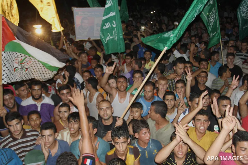 Palestinians gather in the streets celebrating a ceasefire in Khanyounis southern Gaza strip, on 26 August 2014. Palestinian President Mahmoud Abbas announced on 26 August 2014 an Egyptian-brokered ceasefire proposal to...