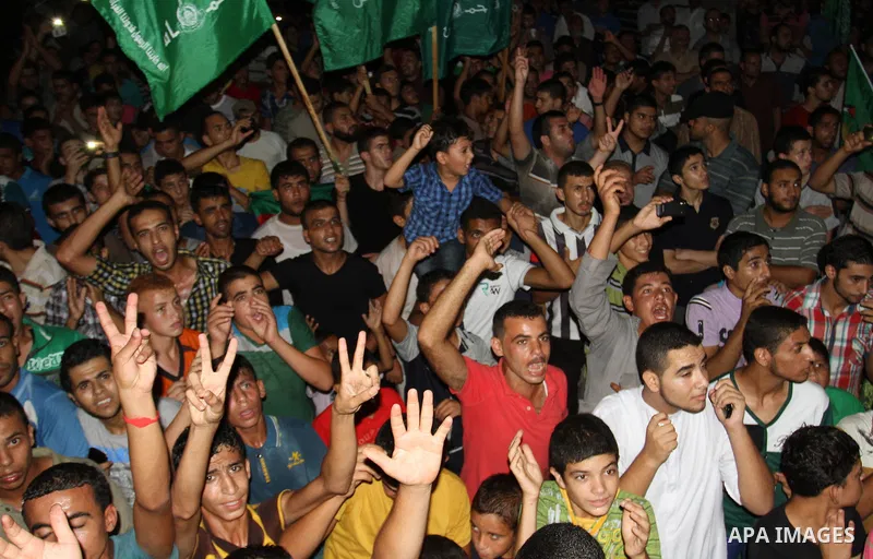 Palestinians gather in the streets celebrating a ceasefire in Khanyounis southern Gaza strip, on 26 August 2014. Palestinian President Mahmoud Abbas announced on 26 August 2014 an Egyptian-brokered ceasefire proposal to...