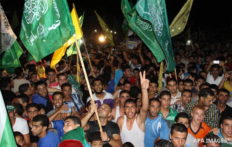 Palestinians gather in the streets celebrating a ceasefire in Khanyounis southern Gaza strip, on 26 August 2014. Palestinian President Mahmoud Abbas announced on 26 August 2014 an Egyptian-brokered ceasefire proposal to...