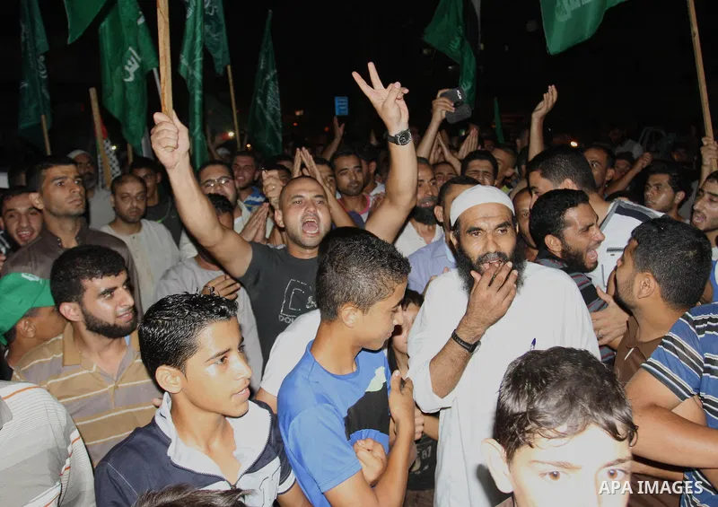 Palestinians gather in the streets celebrating a ceasefire in Khanyounis southern Gaza strip, on 26 August 2014. Palestinian President Mahmoud Abbas announced on 26 August 2014 an Egyptian-brokered ceasefire proposal to...
