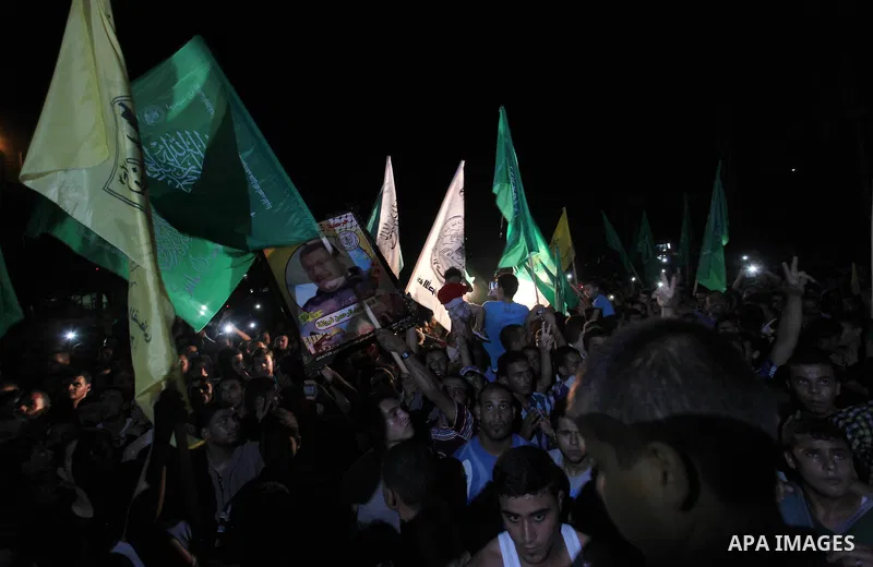 Palestinians gather in the streets celebrating a ceasefire in Khanyounis southern Gaza strip, on 26 August 2014. Palestinian President Mahmoud Abbas announced on 26 August 2014 an Egyptian-brokered ceasefire proposal to...