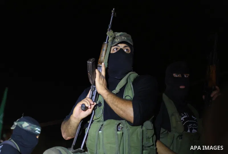 A Palestinian Hamas militant holds his weapon as he celebrate with people what they said was a victory over Israel, following a ceasefire in Gaza City August 26, 2014. A ceasefire agreement between Israel and the Palesti...