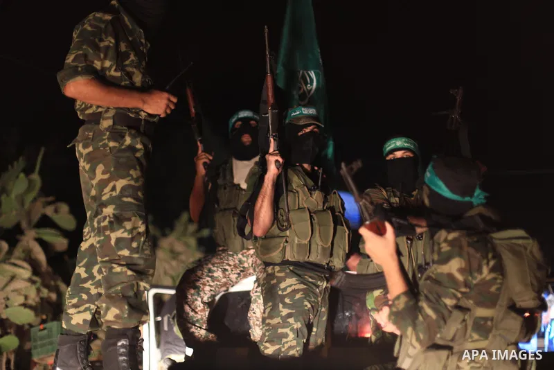 Palestinian Hamas militants hold their weapons as they celebrate with people what they said was a victory over Israel, following a ceasefire in Gaza City August 26, 2014. A ceasefire agreement between Israel and the Pale...