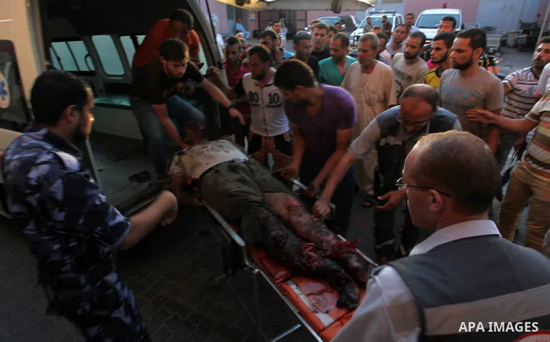 Palestinian medics gather around the body of Palestinian man, whom medics said was killed in an Israeli air strike, during his funeral in Khan Younis in the southern Gaza Strip August 26, 2014. Palestinian President Mahm...
