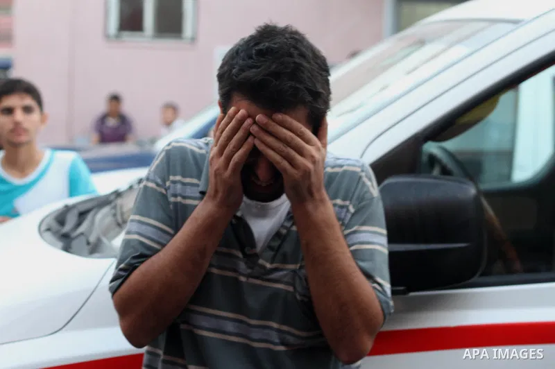 A Palestinian relative mourns on the body of Palestinian man, whom medics said was killed in an Israeli air strike, during his funeral in Khan Younis in the southern Gaza Strip August 26, 2014. Palestinian President Mahm...