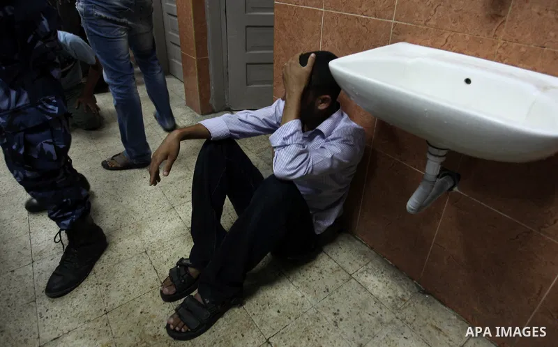 A Palestinian relative mourns on the body of Palestinian man, whom medics said was killed in an Israeli air strike, during his funeral in Khan Younis in the southern Gaza Strip August 26, 2014. Palestinian President Mahm...