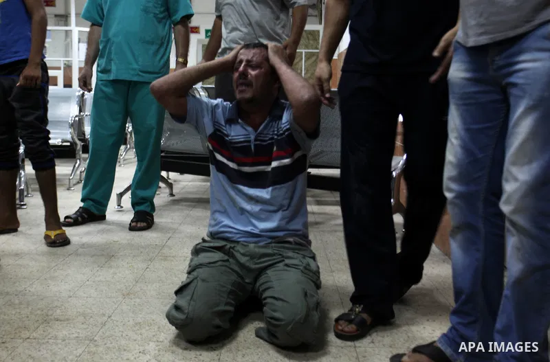 A Palestinian relative mourns on the body of Palestinian man, whom medics said was killed in an Israeli air strike, during his funeral in Khan Younis in the southern Gaza Strip August 26, 2014. Palestinian President Mahm...