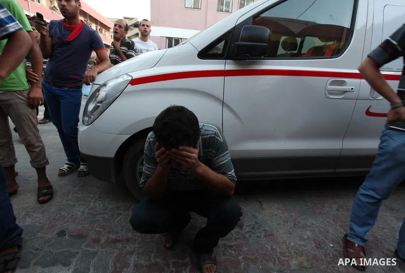 A Palestinian relative mourns on the body of Palestinian man, whom medics said was killed in an Israeli air strike, during his funeral in Khan Younis in the southern Gaza Strip August 26, 2014. Palestinian President Mahm...