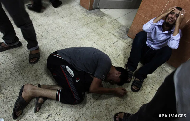 Palestinian relatives mourn on the body of Palestinian man, whom medics said was killed in an Israeli air strike, during his funeral in Khan Younis in the southern Gaza Strip August 26, 2014. Palestinian President Mahmou...