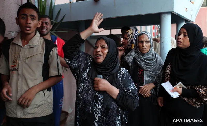 Palestinian relatives mourn on the body of Palestinian man, whom medics said was killed in an Israeli air strike, during his funeral in Khan Younis in the southern Gaza Strip August 26, 2014. Palestinian President Mahmou...