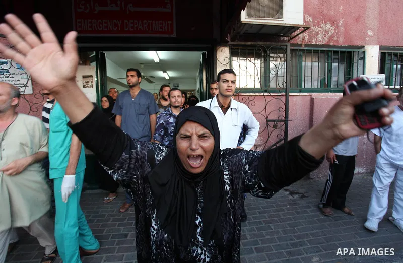 Palestinian relatives mourn on the body of Palestinian man, whom medics said was killed in an Israeli air strike, during his funeral in Khan Younis in the southern Gaza Strip August 26, 2014. Palestinian President Mahmou...