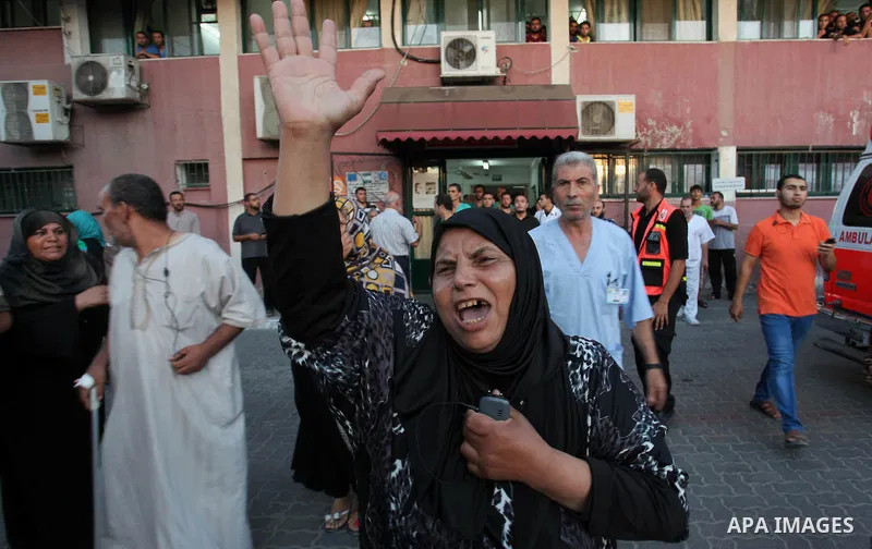 Palestinian relatives mourn on the body of Palestinian man, whom medics said was killed in an Israeli air strike, during his funeral in Khan Younis in the southern Gaza Strip August 26, 2014. Palestinian President Mahmou...