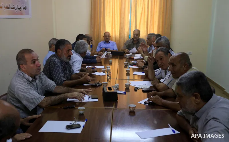 Members of Palestinian factions speak during a press conference in Gaza city. The open-ended ceasefire in the Gaza war between Israel and the Palestinians held on Wednesday as Prime Minister Benjamin Netanyahu faced stro...