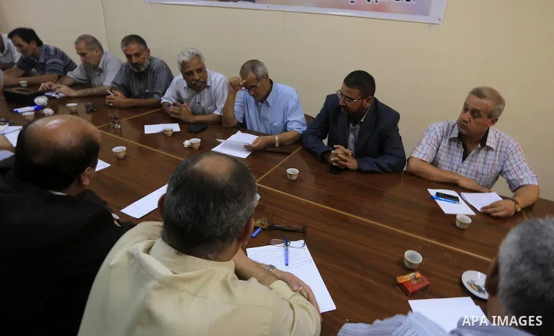 Members of Palestinian factions speak during a press conference in Gaza city. The open-ended ceasefire in the Gaza war between Israel and the Palestinians held on Wednesday as Prime Minister Benjamin Netanyahu faced stro...