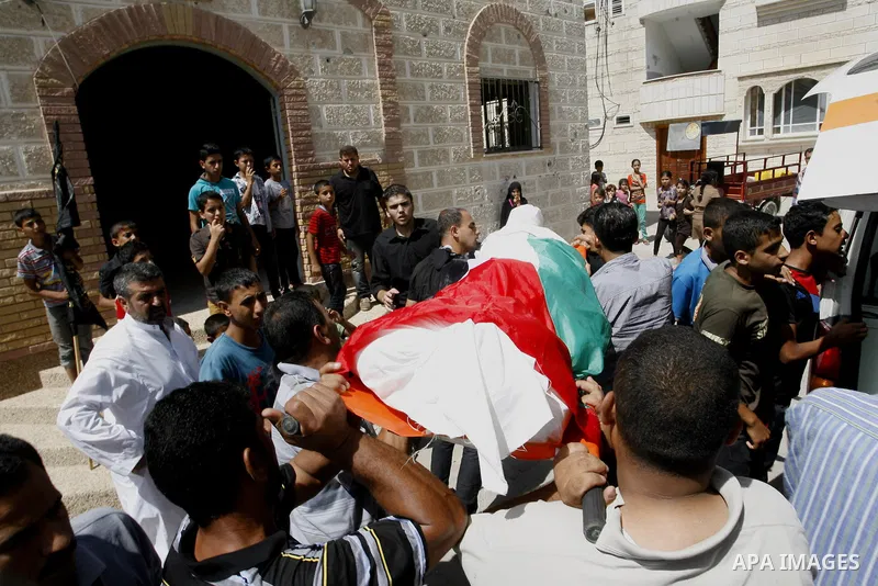 Mourners carry the bodies of two Palestinian children Mohammed and Oamr al-Brim who witnesses said were killed in an Israeli air strike before a ceasefire was declared, during their funeral in Khan Younis in the southern...