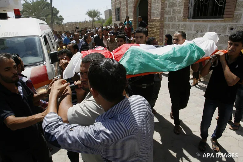 Mourners carry the bodies of two Palestinian children Mohammed and Oamr al-Brim who witnesses said were killed in an Israeli air strike before a ceasefire was declared, during their funeral in Khan Younis in the southern...