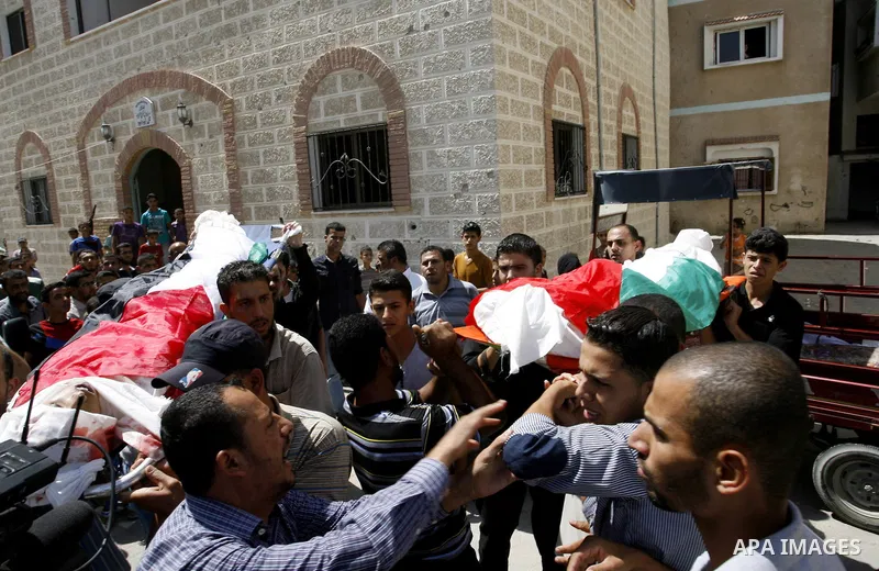 Mourners carry the bodies of two Palestinian children Mohammed and Oamr al-Brim who witnesses said were killed in an Israeli air strike before a ceasefire was declared, during their funeral in Khan Younis in the southern...