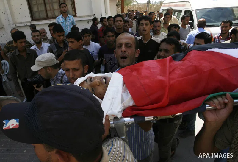 Mourners carry the bodies of two Palestinian children Mohammed and Oamr al-Brim who witnesses said were killed in an Israeli air strike before a ceasefire was declared, during their funeral in Khan Younis in the southern...