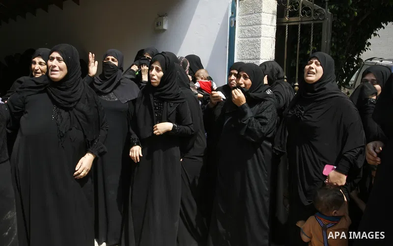 Relatives of two Palestinian children Mohammed and Oamr al-Brim, who witnesses said were killed in an Israeli air strike before a ceasefire was declared, mourn during their funeral in Khan Younis in the southern Gaza Str...