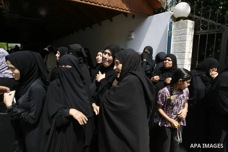 Relatives of two Palestinian children Mohammed and Oamr al-Brim, who witnesses said were killed in an Israeli air strike before a ceasefire was declared, mourn during their funeral in Khan Younis in the southern Gaza Str...